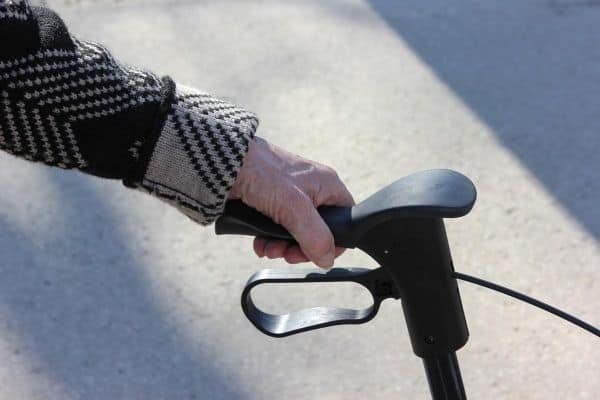 Person holding rollator handle