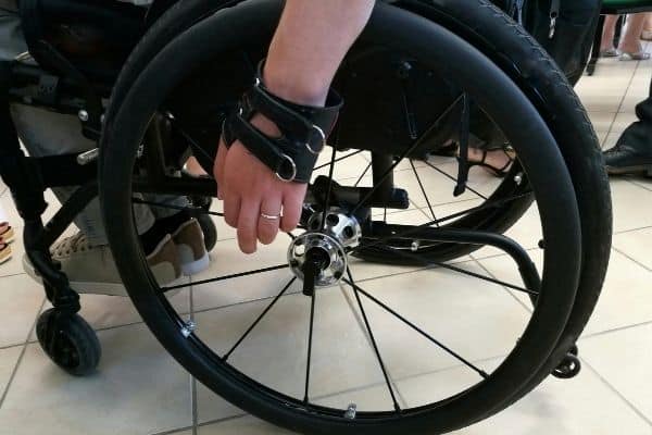 Man on wheelchair with leather gloves