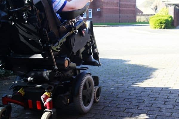 Person using electric wheelchair outside