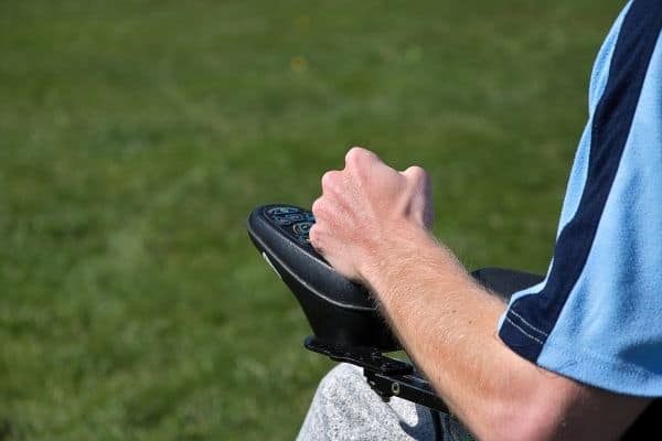 Person holding electric wheelchair control