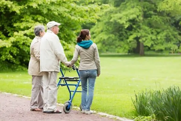 Elderly on rollator travelling with family