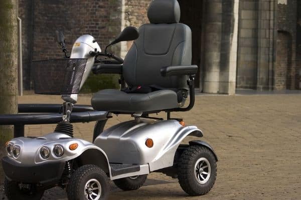 Gray and black mobility scooter parked outdoors