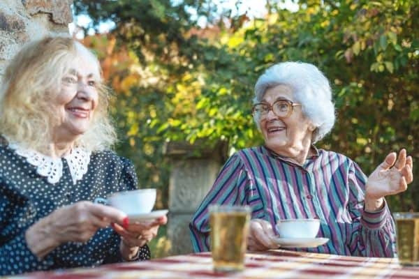 Elderly women talking while having a cup of tea