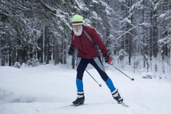 Elderly person skiing on flat land