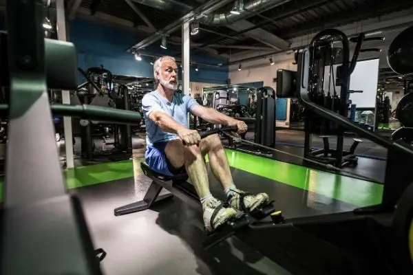 Elderly person using a rowing machine