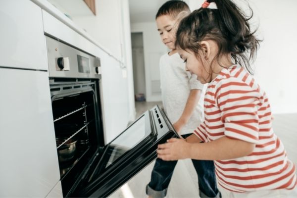 children opening an oven